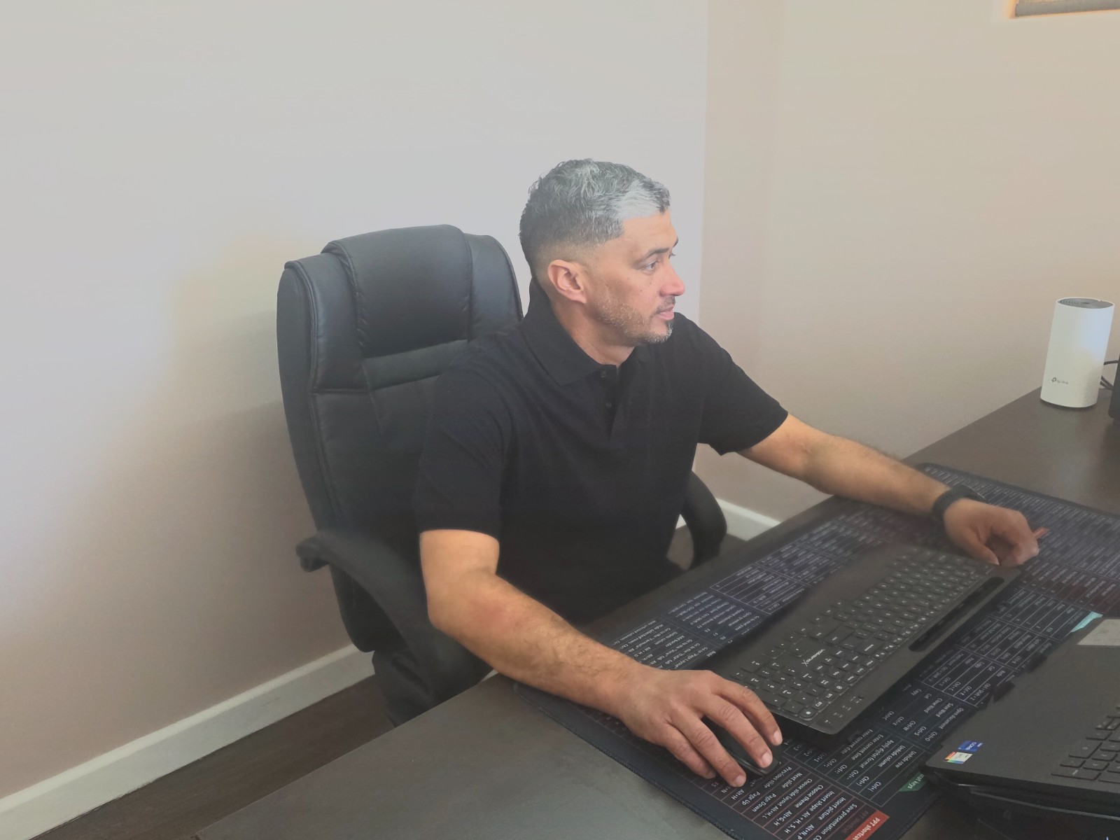 Warren Peplouw, Director of FN Building Projects, at his desk