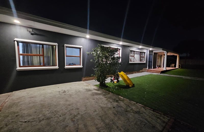 Completed home renovation at Townsend Estate, Goodwood, at night, showing the repainted exterior and new garden