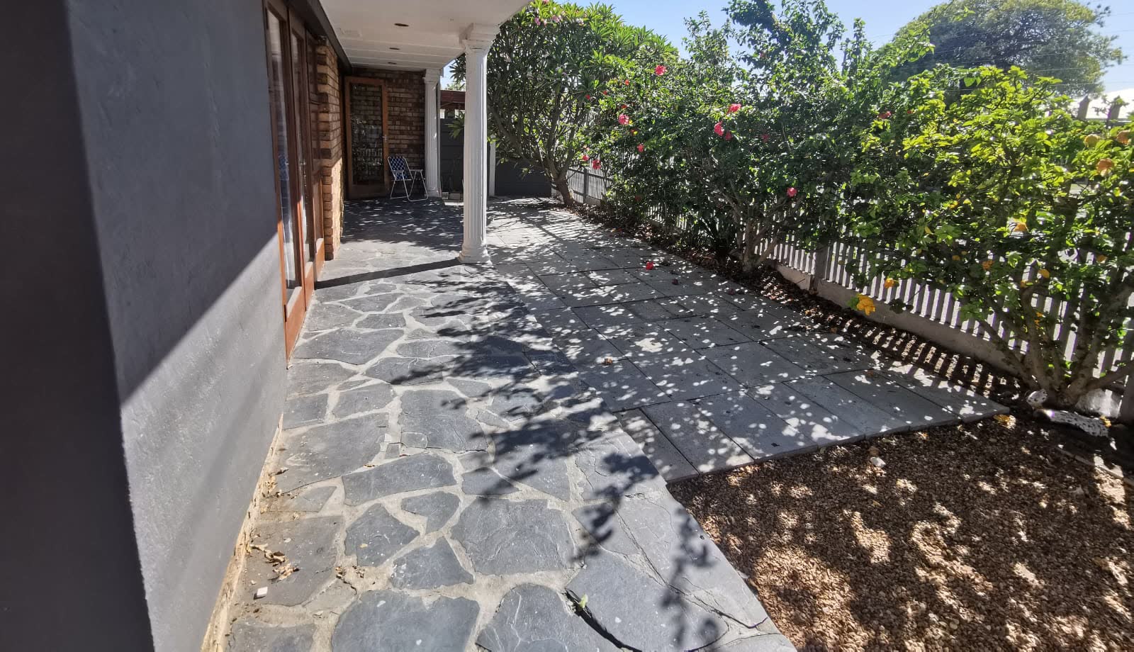 The Townsend Estate patio before renovation, with old crazy paving and no cover